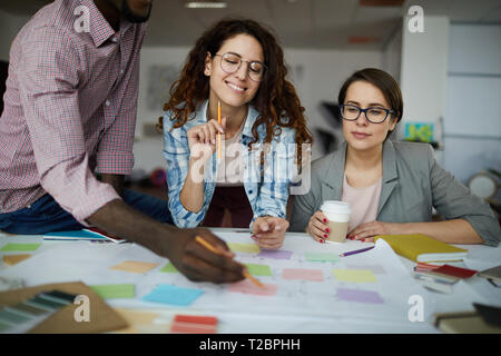 Portrait of contemporary business team planning project drawing roadmap in office, copy space Stock Photo