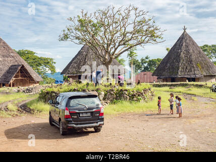 Ruteng Puu tradtional village, Flores island, Indonesia. Indonesian family making visit to the local graves of their ancestors. Rural Asia lifestyle Stock Photo