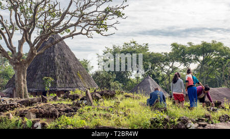 Ruteng Puu tradtional village, Flores island, Indonesia. Indonesian family making visit to the local graves of their ancestors. Rural Asia lifestyle Stock Photo