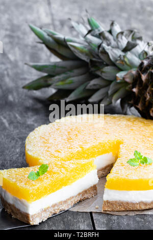 Healthy  layered pineapple cheese cake on wooden table Stock Photo