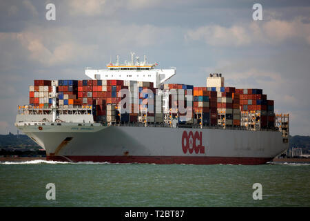 empty,passing,Container, Ship, OOCL, Brussels, leaving, Southampton, Terminal, lightly, loaded, box, export, import, The Solent, Cowes, isle of Wight, Stock Photo