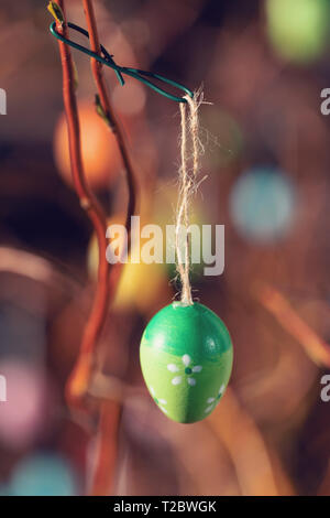 Hanging Easter eggs on tree with soft focus bokeh and color toned. Spring easter concept background. Stock Photo