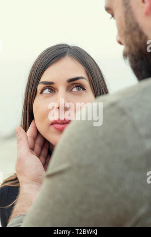 Man touching woman's face outdoors Stock Photo