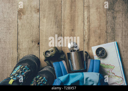 Children's set of equipment for hiking in the mountains on a wooden background Stock Photo