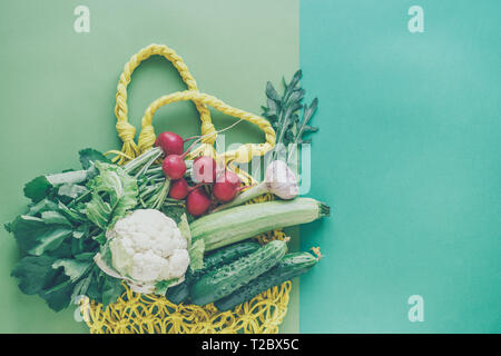 Vegetables on the table on the wicker bag hendikraft, shopping in the supermarket, the ingredients for a healthy dinner Stock Photo