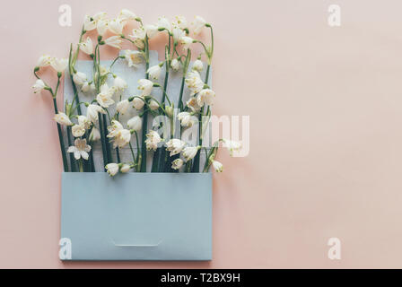 Delicate bouquet of flowers of snowdrops in the mail envelope. Springtime festive mood. Stock Photo