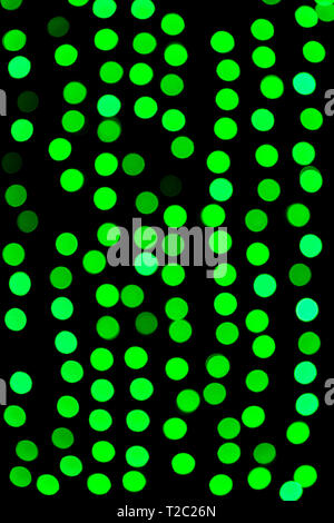 Unfocused abstract green bokeh on black background. defocused and blurred many round light. Stock Photo