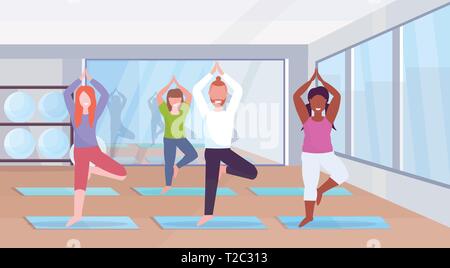 sporty man women group doing yoga exercises mix race people meditating standing in tree position working out healthy lifestyle concept modern gym Stock Vector