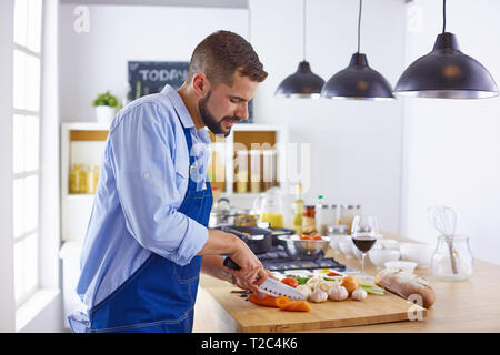 Young chef prepares a man in the kitchen. Stock Photo