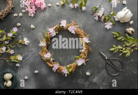 Spring wreath with flowers on dark. Creative flat lay. Top view. Decor handmade. Stock Photo