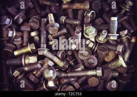 Nuts Bolts Background. lots of metal bolts. tinted photo. Stock Photo