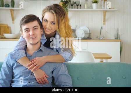 beautiful girl hugging a guy in the kitchen, , copy space Stock Photo