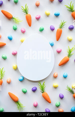 Easter seasonal background with colourful eggs and carrots Stock Photo