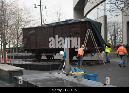 New York, USA. 31st Mar, 2019. A German National Railroad freight car was installed on the plaza in front of the Museum of Jewish Heritage in Battery Park City, Manhattan, New York, as part of the museum’s upcoming exhibition, “Auschwitz. Not long ago. Not far away.” This freight car, which would have been packed with 80 to 100 people, was one of many that the Nazis employed to transport people — most of them, Jews — to Auschwitz to be killed. Credit: Terese Loeb Kreuzer/Alamy Live News Stock Photo