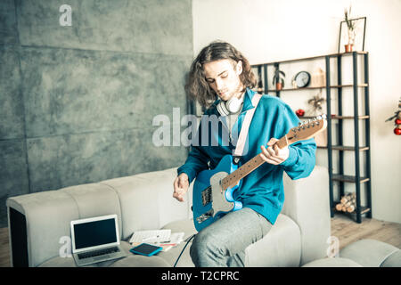 Creative young musician being involved in music repetition Stock Photo