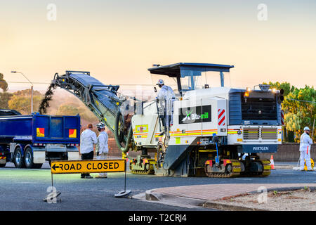 Adelaide, South Australia - November 27, 2017: Night works for new road profiling and asphalt lay with use of modern cold milling machine on Springban Stock Photo