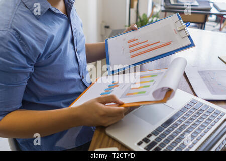 Male hand holding financial reports and reading  Stock Photo