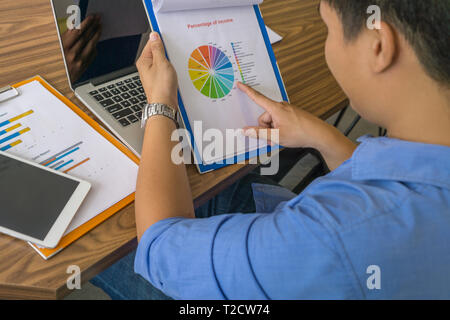 Businessman reading financial reports in the office Stock Photo