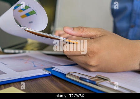 Close up photo of man hand holding financial reports Stock Photo