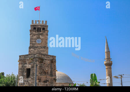 Clock tower and mosque with minaret in background. Antalya, Turkey. Stock Photo