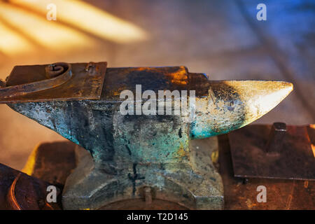 Old anvil in the blacksmith shop. Close-up of a metal tool. Stock Photo