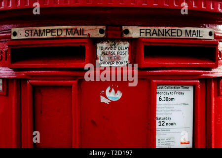 red post box for stamped mail and franked mail in London, Great Britain Stock Photo