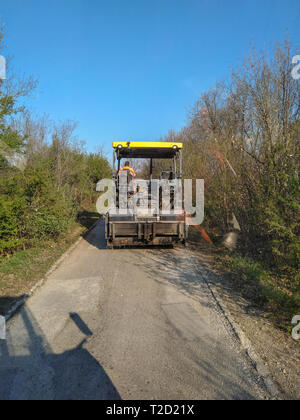 Kladovo, Serbia - April 01, 2019: Asphalting the streets in the city see finisher who are ready to sets asphalt in Kladovo, Serbia Stock Photo