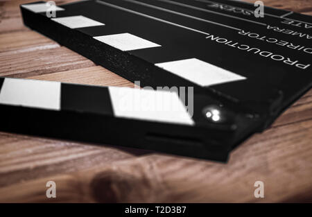 Selective focus of a Clapper board on a wood surface, cinema and videomaking concep Stock Photo