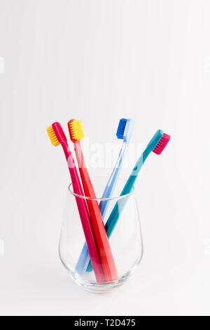 Cup with toothbrushes isolated on white background. Dental care Stock Photo