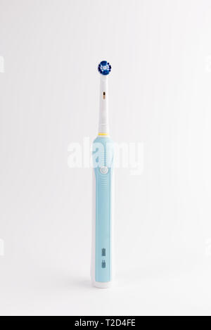 Modern electric toothbrush stands isolated on white Stock Photo