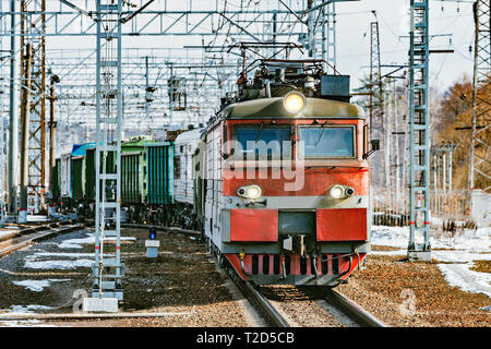 Long freight train approaches to the station. Stock Photo