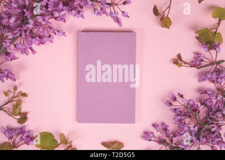 Flowers composition. Paper blank, pink flowers on pastel blue background. Flat lay, top view, copy space, square Stock Photo