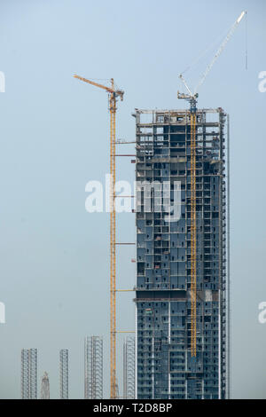 Skyscraper under construction with two cranes Stock Photo
