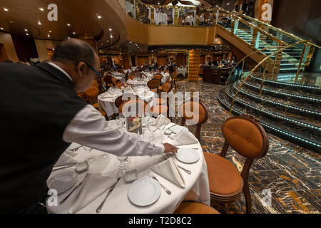 Waiter setting the table at a upscale luxurious restaurant Stock Photo
