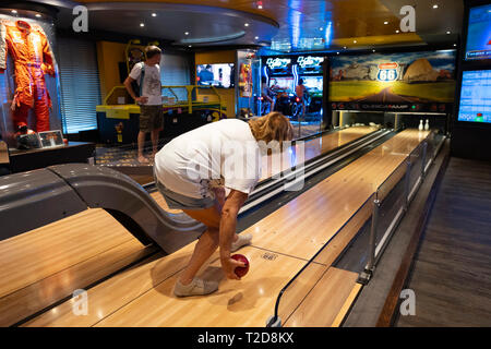 Passenger bowling at the Sports Bar of the MSC Splendida cruise liner ship Stock Photo