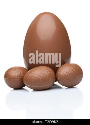 Delicious chocolate Easter eggs and sweets on white background Stock Photo