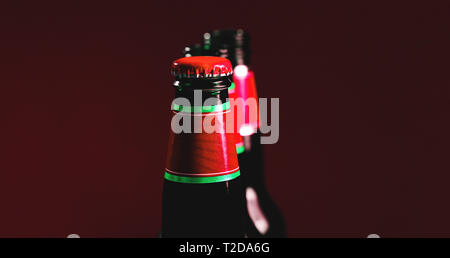 Fancy brown bottle of soft drink. Beer bottles with red cap and colorful textured label. Conceptual picture as template for labels. Stock Photo