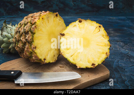 Sliced sweet pineapple on old rustic desk Stock Photo