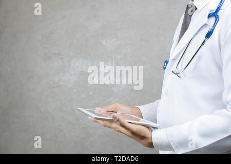 Male doctor using tablet computer at office. Medical research staff and doctor service. - Image Stock Photo