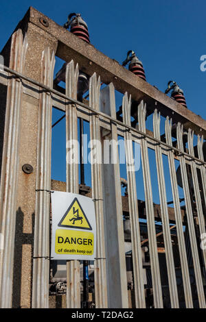 Danger of death keep out warning sign on a palisade fence of a 66KV transformer compound Stock Photo
