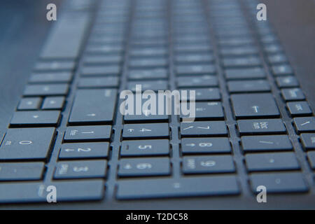 Close up of keyboard of a modern laptop, Computer keyboard close-up with empty space. Stock Photo