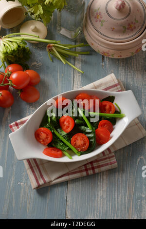 boiled spinach with cherry tomato - closeup Stock Photo
