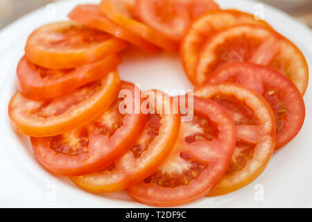 Plate of sliced red tomatoes salad Stock Photo