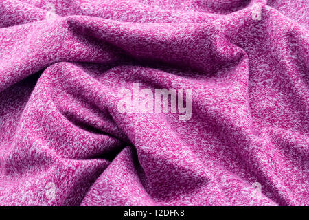 Background of twisted and crumpled fabric purple or burgundy. Stock Photo