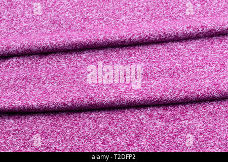 Background from neatly folded fabric of purple or burgundy. Stock Photo