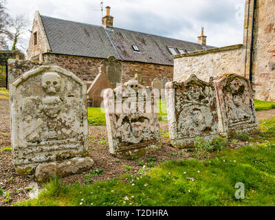 12th century Morham Parish Church and old gravestones with skull and crossbones, East Lothian, Scotland, UK Stock Photo