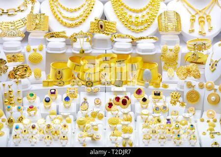 Fashion jewelry from yellow gold with jems, on a window shop Stock Photo