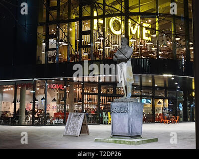 Manchester, United Kingdom - February 17, 2019: Evening capture of HOME centre for international contemporary art, theatre and film and statue of Frie