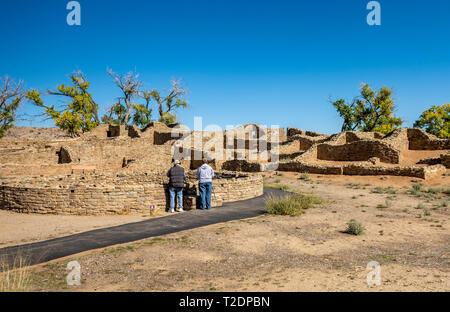 Senior tourists look into an ancestral pueblo kiva at Aztec Ruins National Monument, New Mexico USA Stock Photo