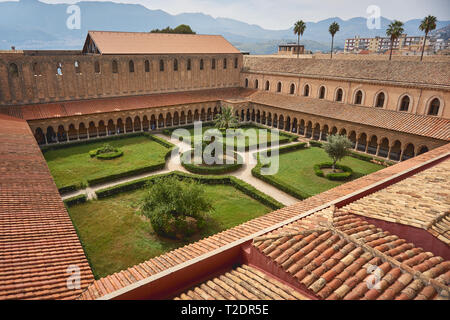 Monreale, Italy - October, 2018. Cloister and garden of the Monreale Cathedral, one of the greatest examples of Norman architecture. Stock Photo